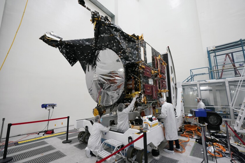 FILE - Technicians work on the Psyche spacecraft at the NASA Jet Propulsion Laboratory, April 11, 2022, in Pasadena, Calif. NASA put an asteroid mission on hold Friday, June 24, 2022, blaming the late delivery of its own navigation software. The Psyche mission to a strange metal asteroid of the same name was supposed to launch this September or October. But the agency’s Jet Propulsion Lab was several months late writing and delivering its software for navigation, guidance and control. (AP Photo/Marcio Jose Sanchez, File)