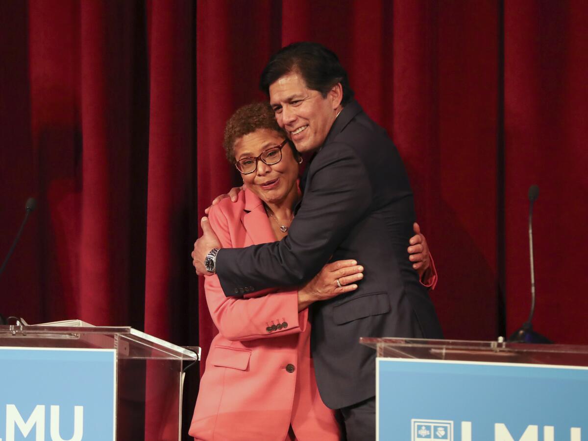 Los Angeles mayoral candidates Kevin de León and Karen Bass embrace as they wrap up the debate.