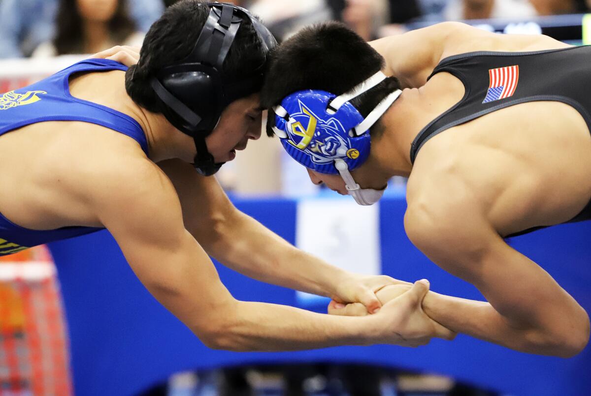 Marina's Adrian Jimenez, left, and Fountain Valley's Anthony Lucio, wrestle at 113 pounds on Feb. 11.