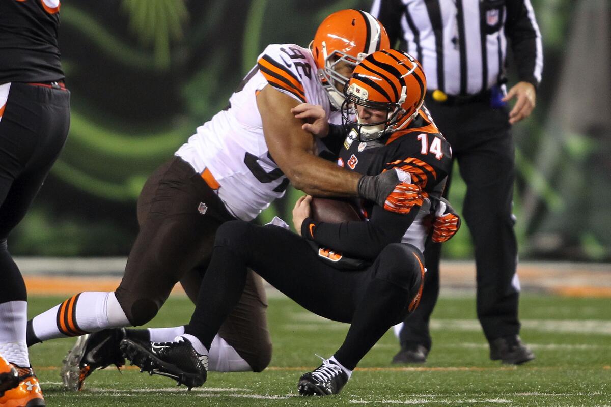 Cincinnati quarterback Andy Dalton is sacked by Cleveland's Desmond Bryant on Thursday night. Bad things happened when Dalton threw it, too.