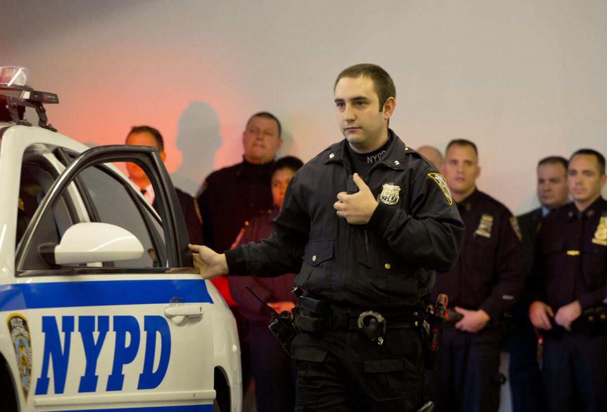 New York Police Department officer Joshua Jones turns on a body camera attached to his chest during a traffic stop training demonstration for the media in New York last December.