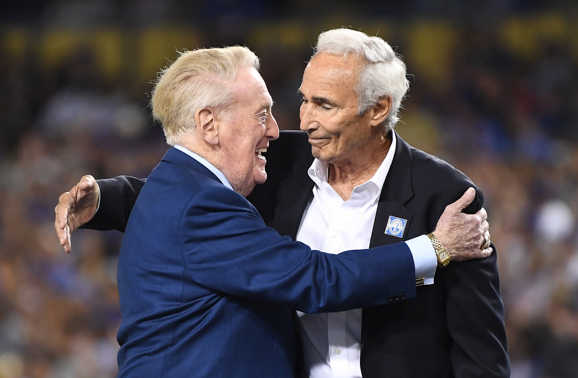 Dodgers announcer Vin Scully hugs former pitcher Sandy Koufax during Vin Scully appreciation night.