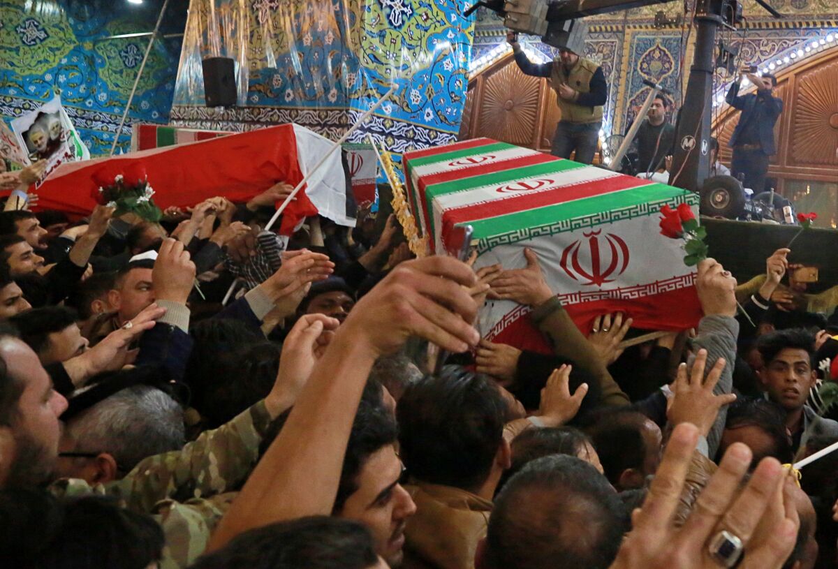 Mourners carry the coffins of Qassem Suleimani, Iran's top general, and Abu Mahdi Muhandis, deputy commander of the Popular Mobilization Forces in Iraq, during their funeral Jan. 4 in Karbala, Iraq. 