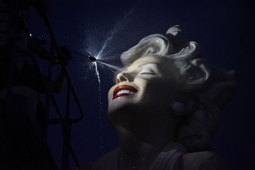 The sculpture "Forever Marilyn" is sprayed in the middle of the night during the sculpture's installation. 