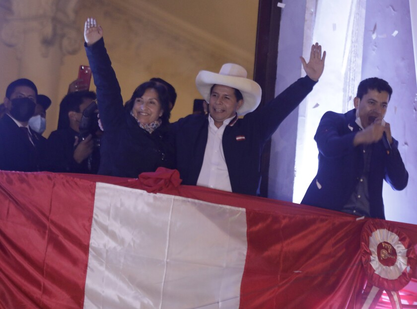 Pedro Castillo celebrates with his running mate, Dina Boluarte, after being declared president-elect of Peru.