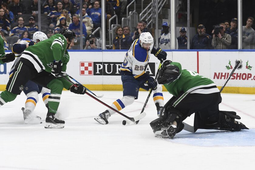 St. Louis Blues' Jordan Kyrou (25) shoots the puck against the Dallas Stars during the second period of an NHL hockey game, Monday, Nov. 28, 2022, in St. Louis. (AP Photo/Michael Thomas)