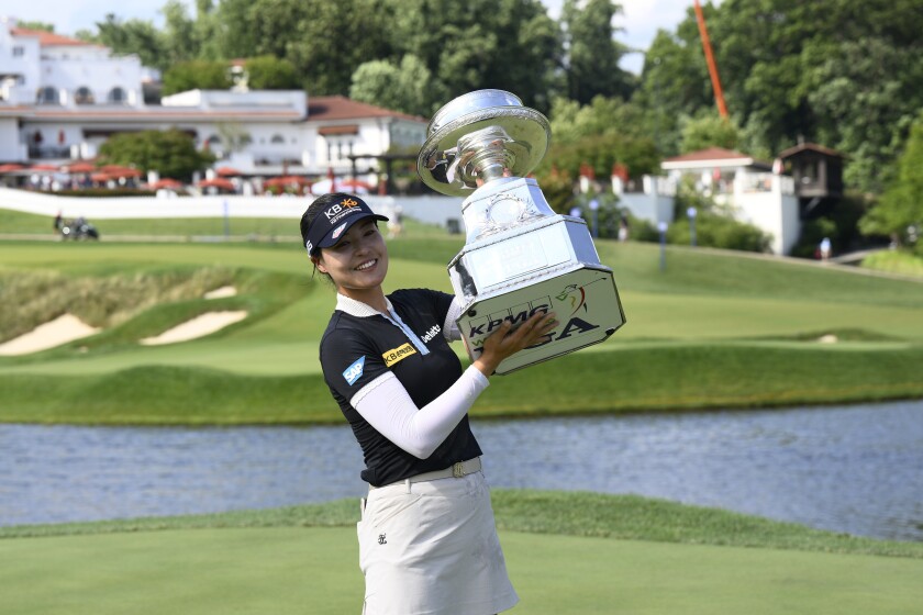 In Gee Chun, of South Korea, poses with the winners trophy after winning the KPMG Women's PGA Championship golf tournament at Congressional Country Club, Sunday, June 26, 2022, in Bethesda, Md. (AP Photo/Nick Wass)