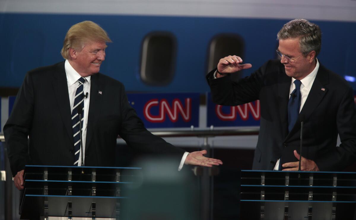 Donald Trump and Jeb Bush high-five during the Republican presidential debate at the Ronald Reagan Presidential Library in Simi Valley on Sept 16.