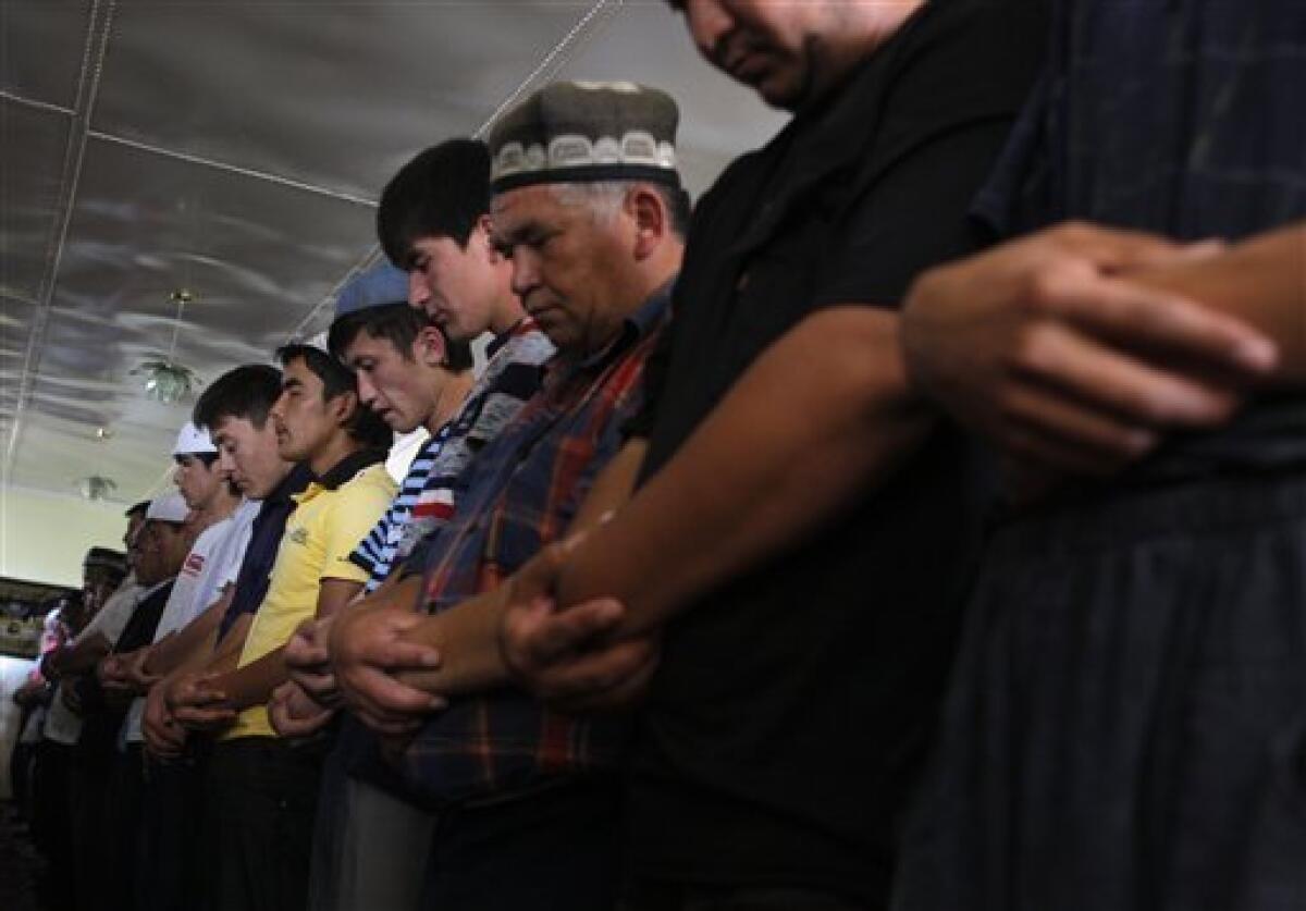 Ethnic Uzbek men seen during a Friday prayer in mosque in Vlksm, the Uzbek neighborhood near the southern Kyrgyz city of Osh, Friday, June 18, 2010. The United Nations said as many as 1 million people may need aid in Kyrgyzstan and Uzbekistan, including the potential number of refugees, internally displaced, host families and others that may suffer in one way or another from the unrest. (AP Photo/Sergei Grits)