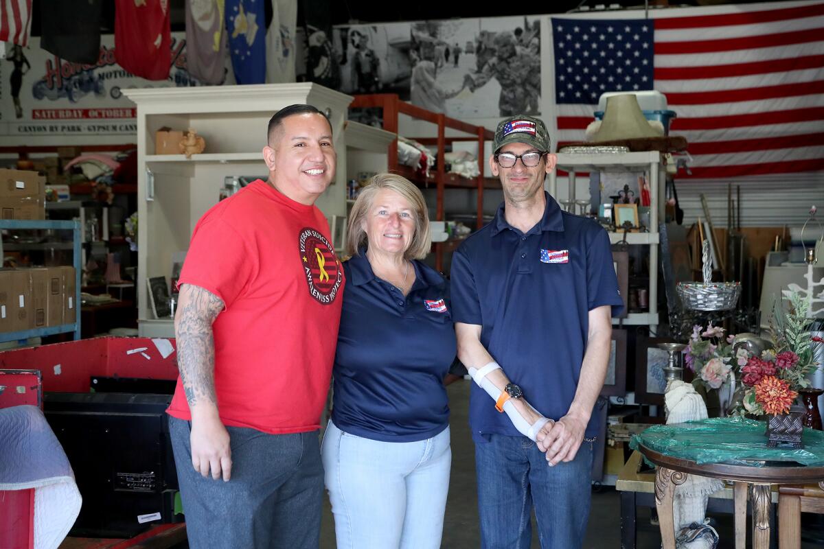 Penny Lambright with Cory Vigil, a veteran post officer, and volunteer Michael Bertrand