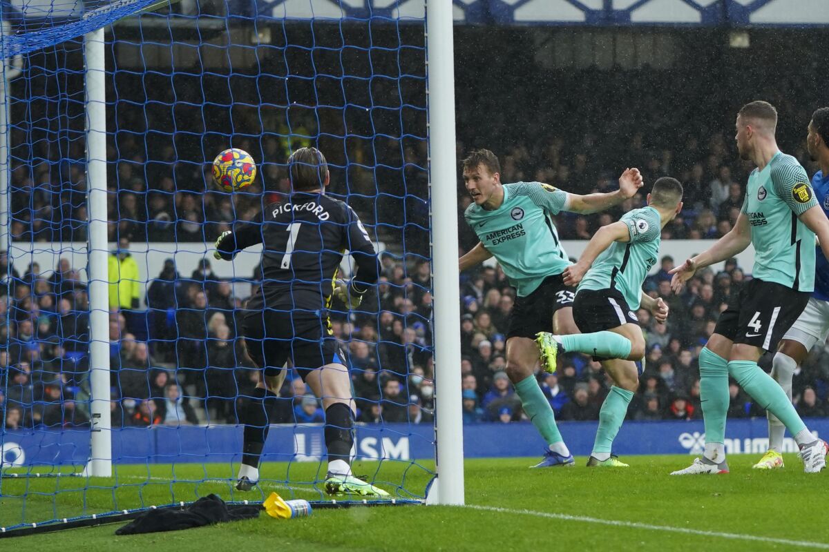 Brighton's Dan Burn, center, heads the ball to score his side's second goal during the English Premier League soccer match between Everton and Brighton at Goodison Park stadium in Liverpool, England, Sunday, Jan. 2, 2022. (AP Photo/Jon Super)
