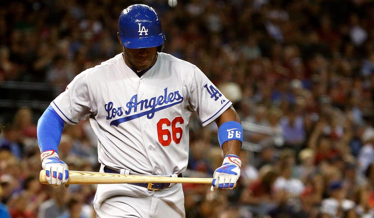 Dodgers' Yasiel Puig reacts after striking out during a 4-3 loss in extra innings to the Arizona Diamondbacks on Friday.