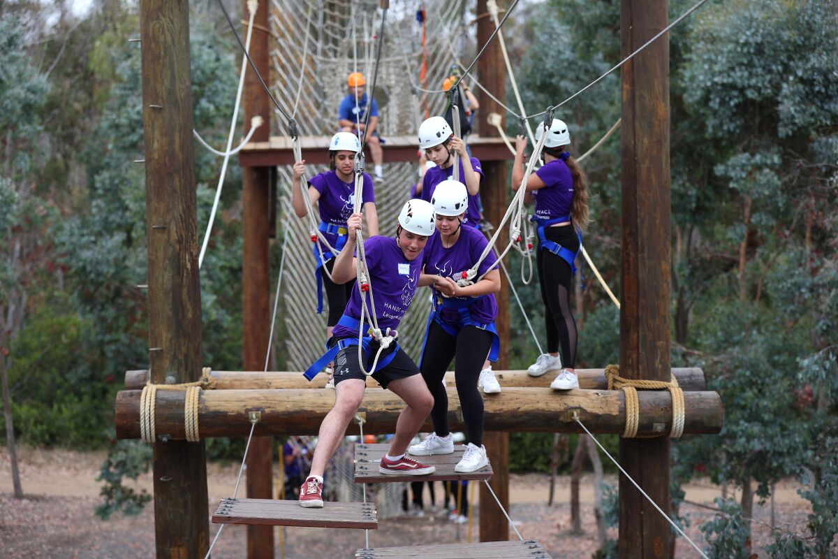 Israeli, Palestinian and American teens work together during a team-building event on the Challenge Course Park at UC San Diego during the annual three-week Hands of Peace summit on Sunday