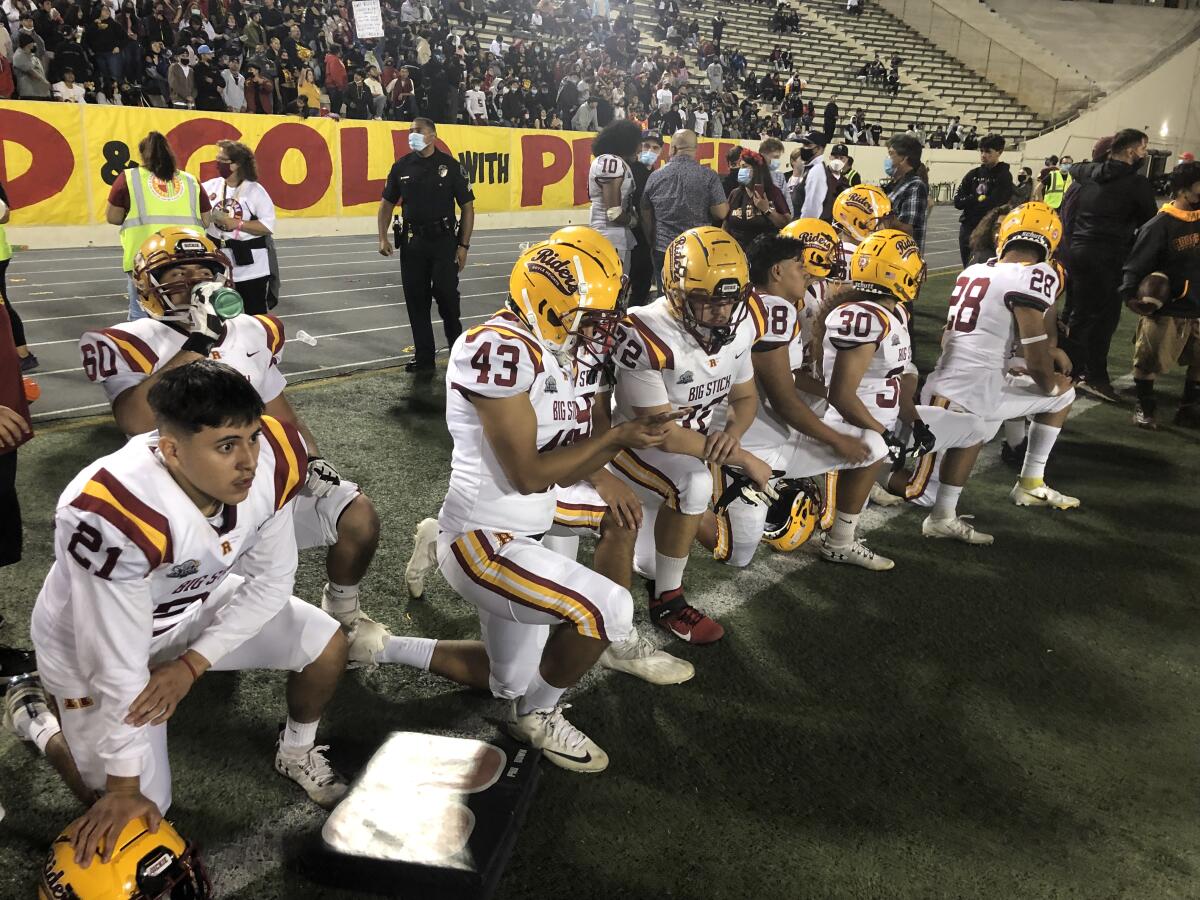 Roosevelt players look on from the sideline during the East L.A. Classic. Their coach will be getting a raise.