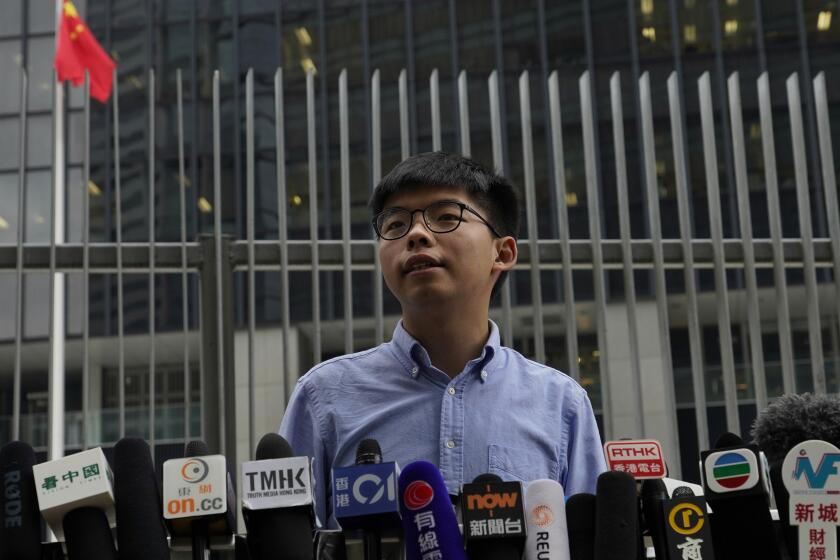 Pro-democracy activist Joshua Wong fields media questions during a news conference in Hong Kong on Tuesday.