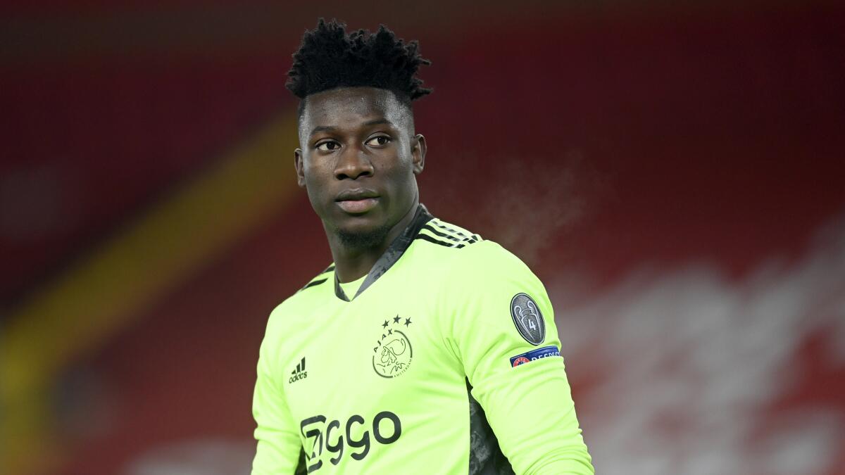 FILE - In this Tuesday, Dec. 1, 2020 file photo, Ajax's goalkeeper Andre Onana looks on during their Champions League group D soccer match against Liverpool at Anfield stadium in Liverpool, England. Onana had his ban for a positive doping test cut to nine months, and will now Nov. 3. The Court of Arbitration for Sport on Thursday, June 10, 2021 said its judges found Onana was not at significant fault and cut his one-year ban by UEFA. (Michael Regan/Pool via AP, file)