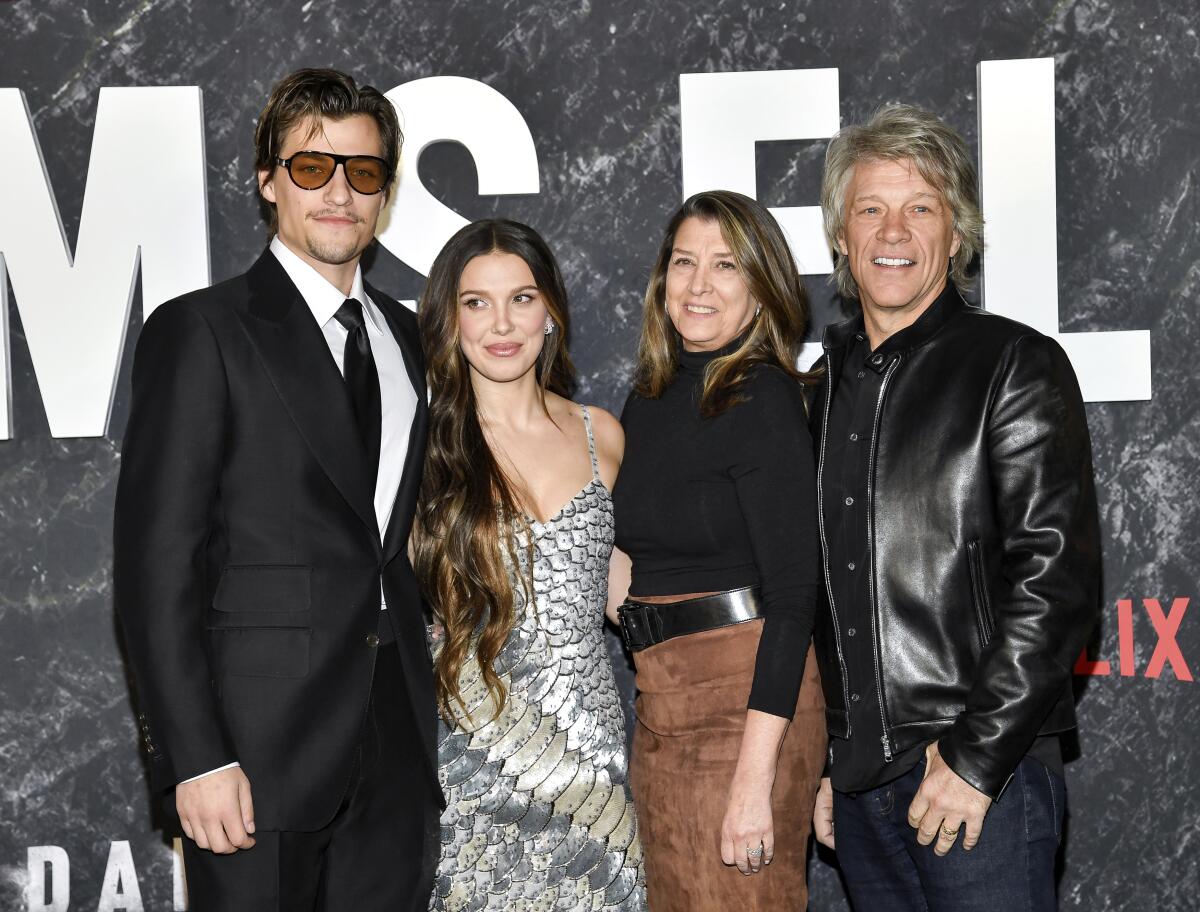 Jake Bongiovi, left, Millie Bobby Brown, Dorothea Bongiovi and Jon Bon Jovi posing side by side