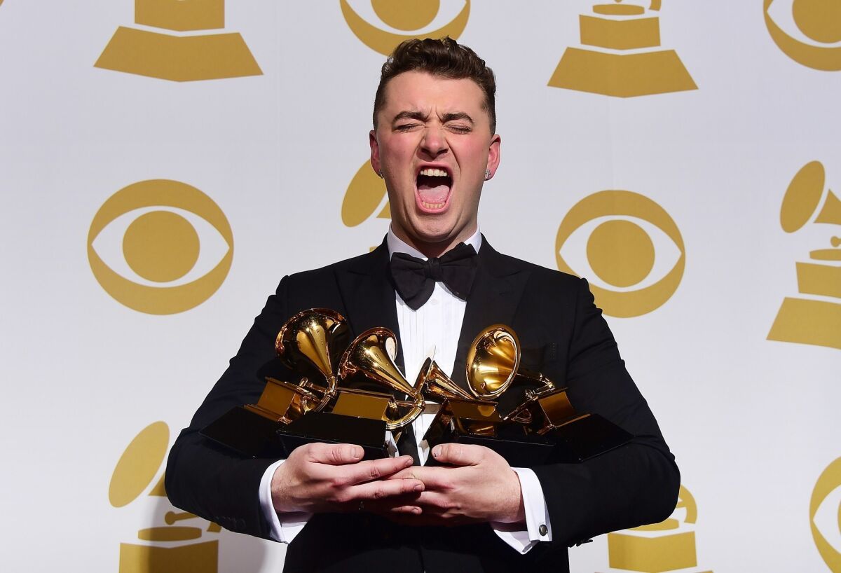 Sam Smith holds the four awards he collected Feb. 8 at the Grammy Awards in Los Angeles.