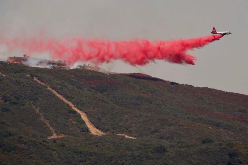 GOLETA, CA - JULY 15, 2017 - Fixed wing aircraft drop phos chek at the Whittier Fire in Goleta Saturday afternoon to assist firefighters as they fight fire with fire through controlled backfires along Camino Cielo in the Santa Ynez Mountains burning away the unburned vegetation to contain and stop the progress on the West flank. The fire which started one week ago Saturday afternoon has consumed 17,364 acres and containment has been scaled back to 35% as the fire swelled overnight fueled ny sundowner winds. (Al Seib / Los Angeles Times)