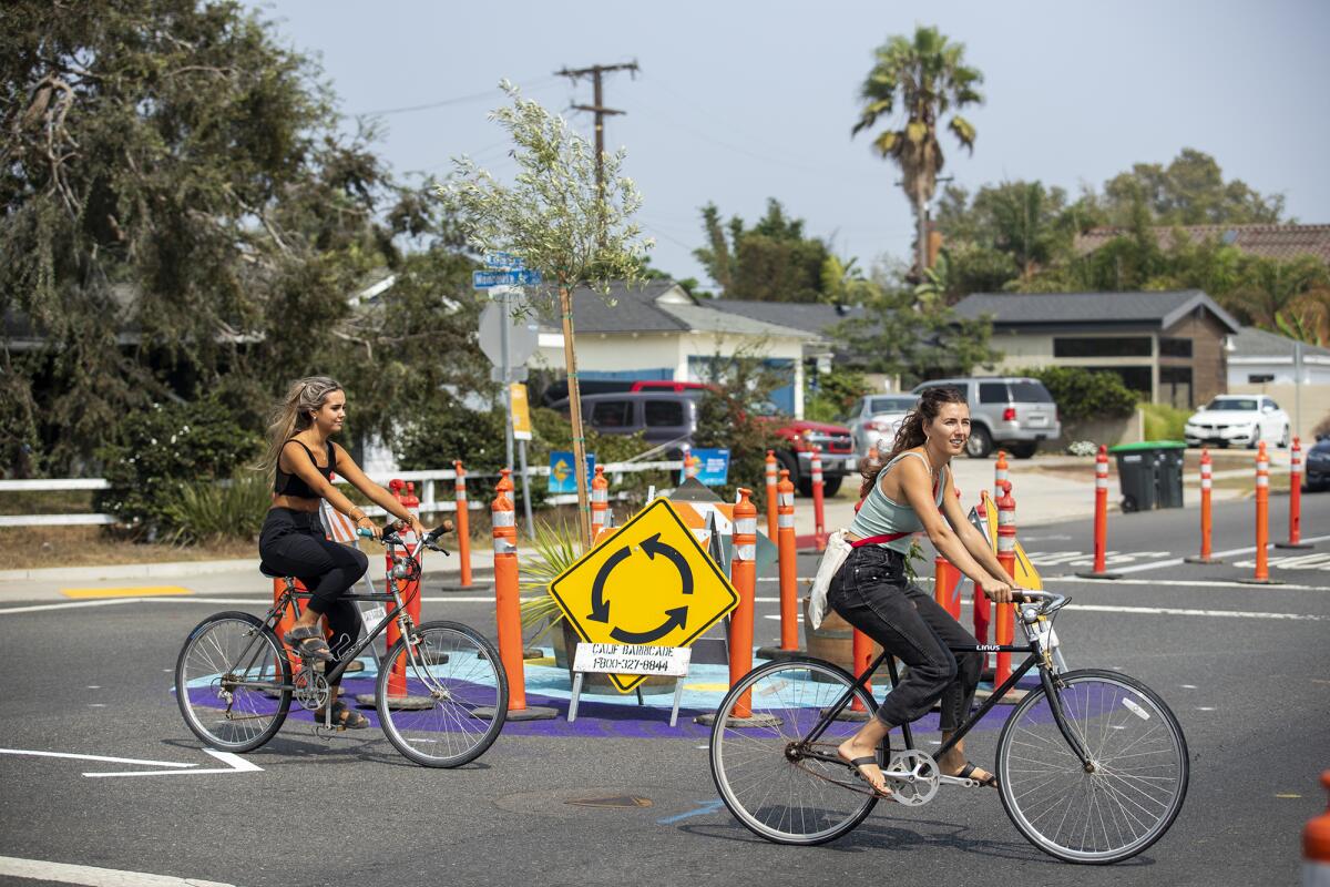Bicyclists ride through an intersection at 19th Street and Monrovia Avenue in Costa Mesa.