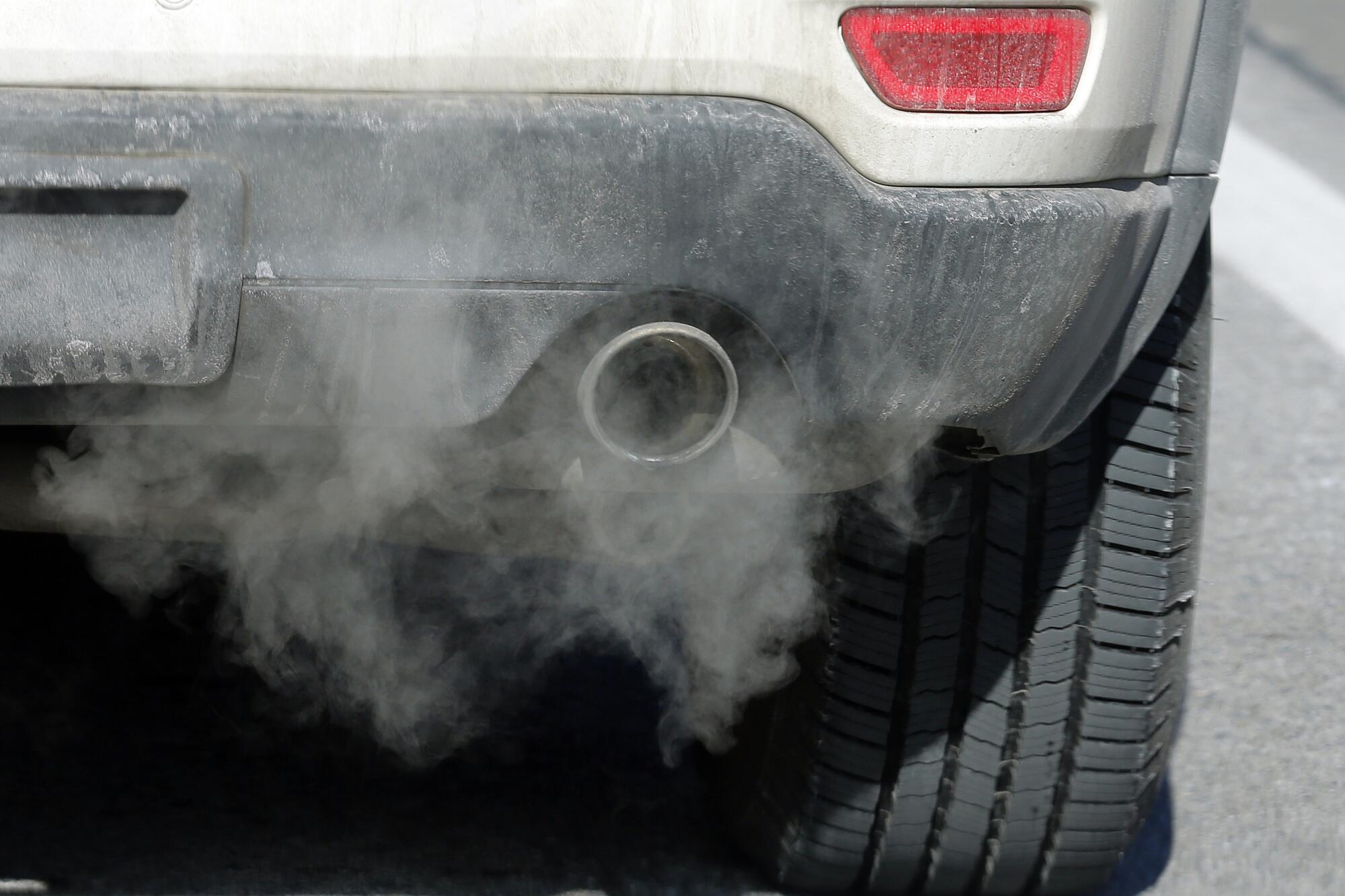 Haze surrounds the exhaust pipe of a car. 