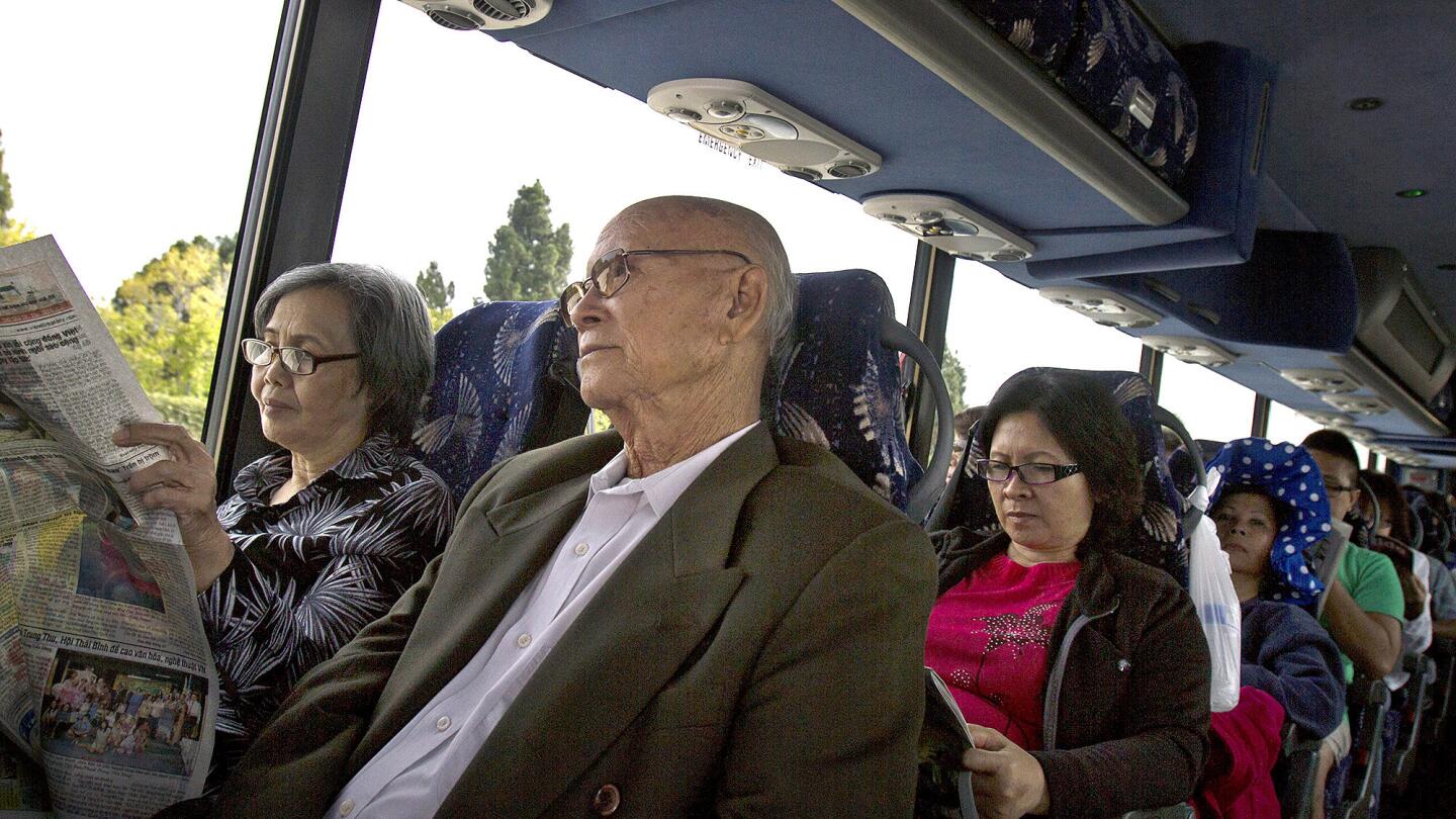 Dong Nguyen, from left, Tau Pham, 81, and other passengers travel from Westminster to San Jose. The music that spills from the speakers is from "Paris by Night," the long-running and ever-popular Vietnamese variety show.