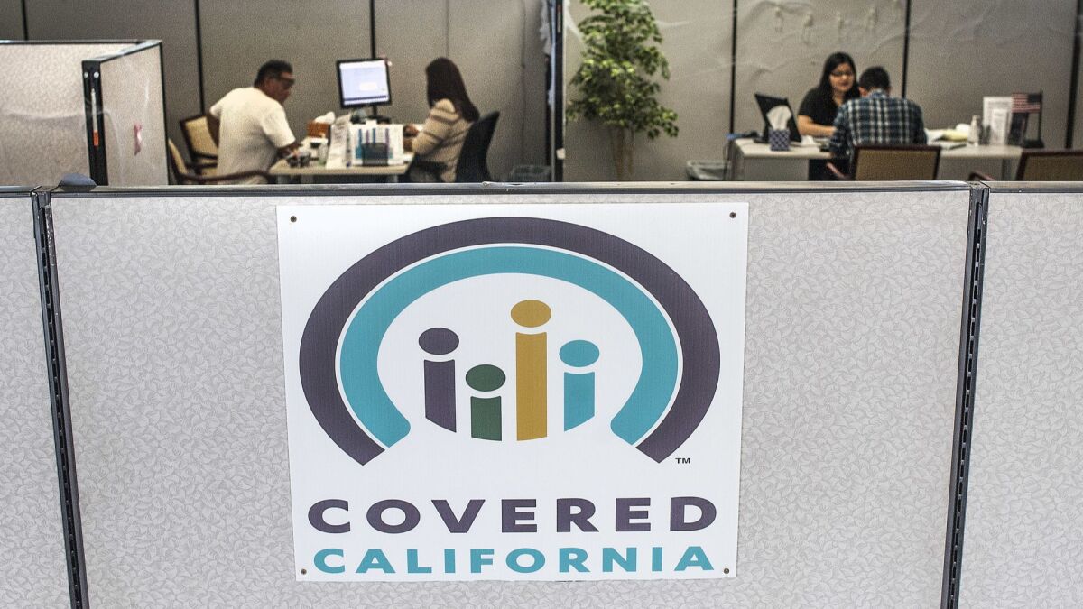 Insurance agents help sign people up for insurance through the Covered California exchange at their storefront on Beach Blvd. in Huntington Beach, Calif., Tuesday, Nov. 1, 2016.