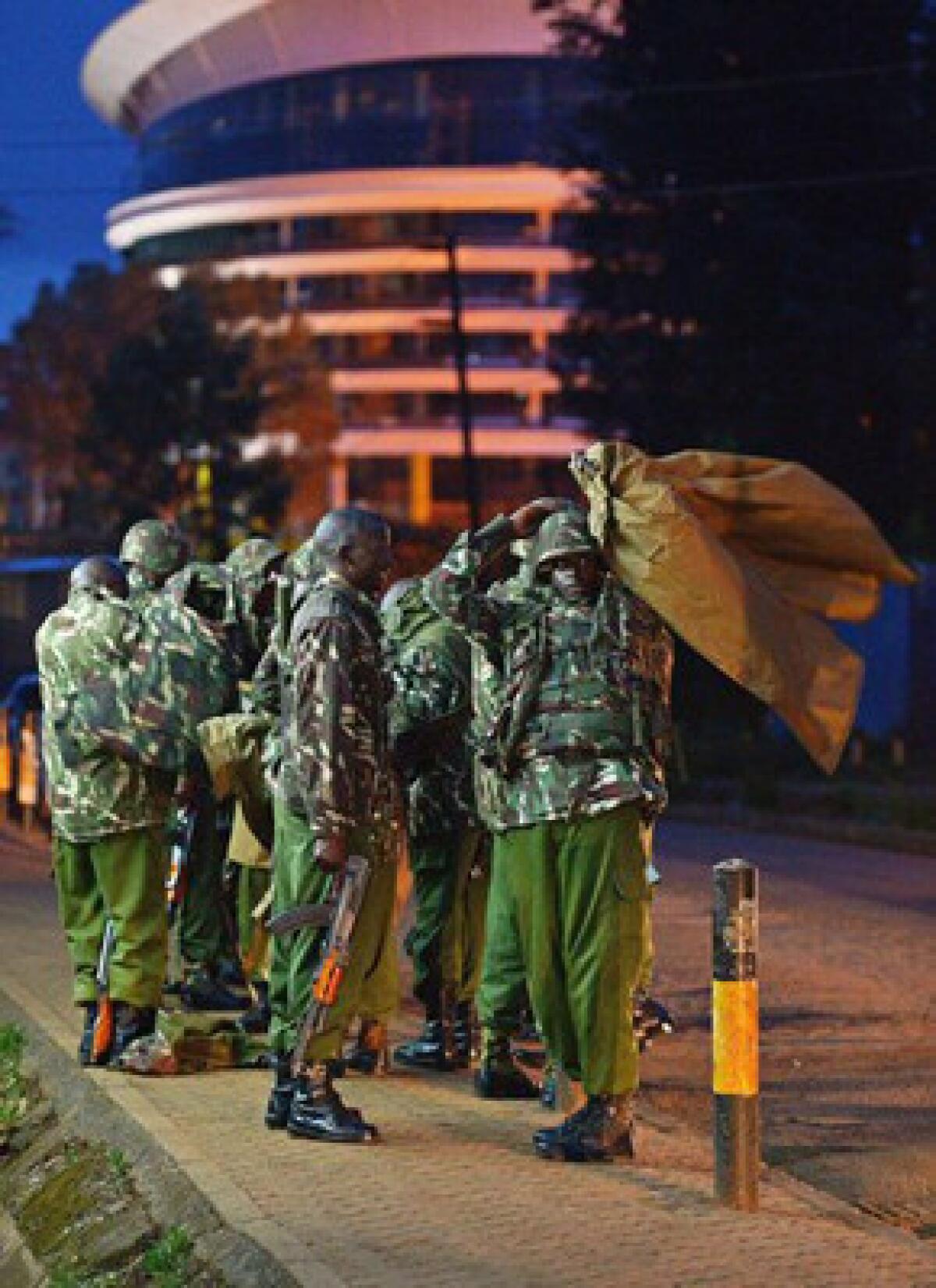 Kenyan police stand guard near Westgate mall in Nairobi on Sunday.