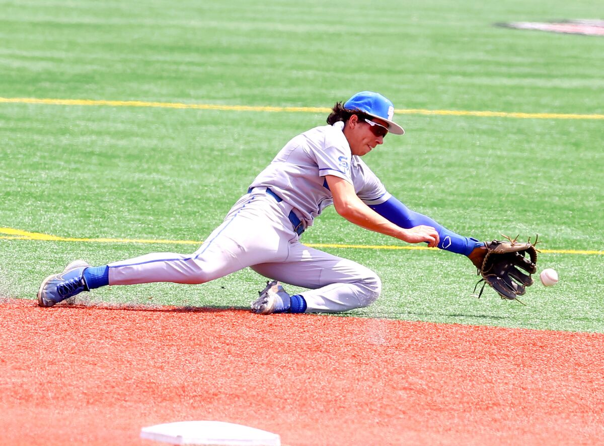 Jared Saldana of Santa Margarita makes diving catch in 2-1 victory over Corona on Tuesday in the Boras Classic.