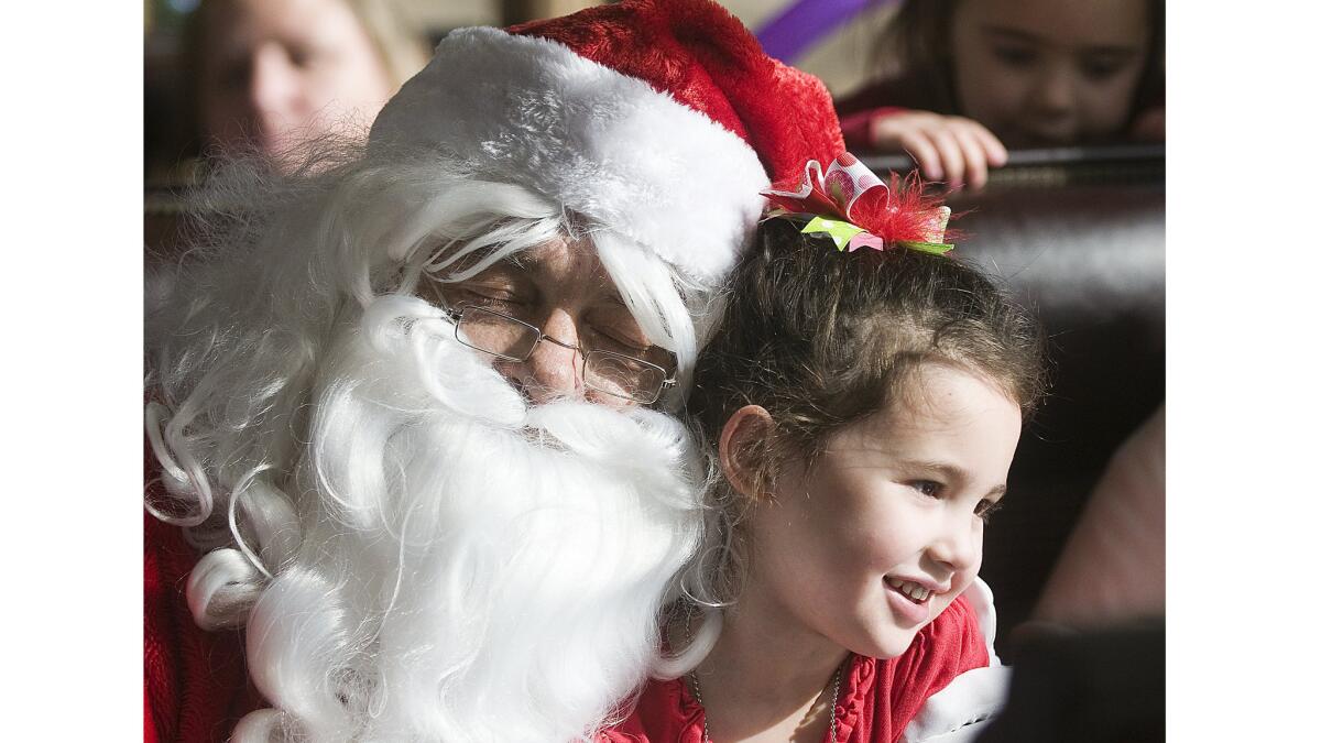 Santa Claus entertains children during BNSF's Holiday Express train ride between Victorville and Barstow.