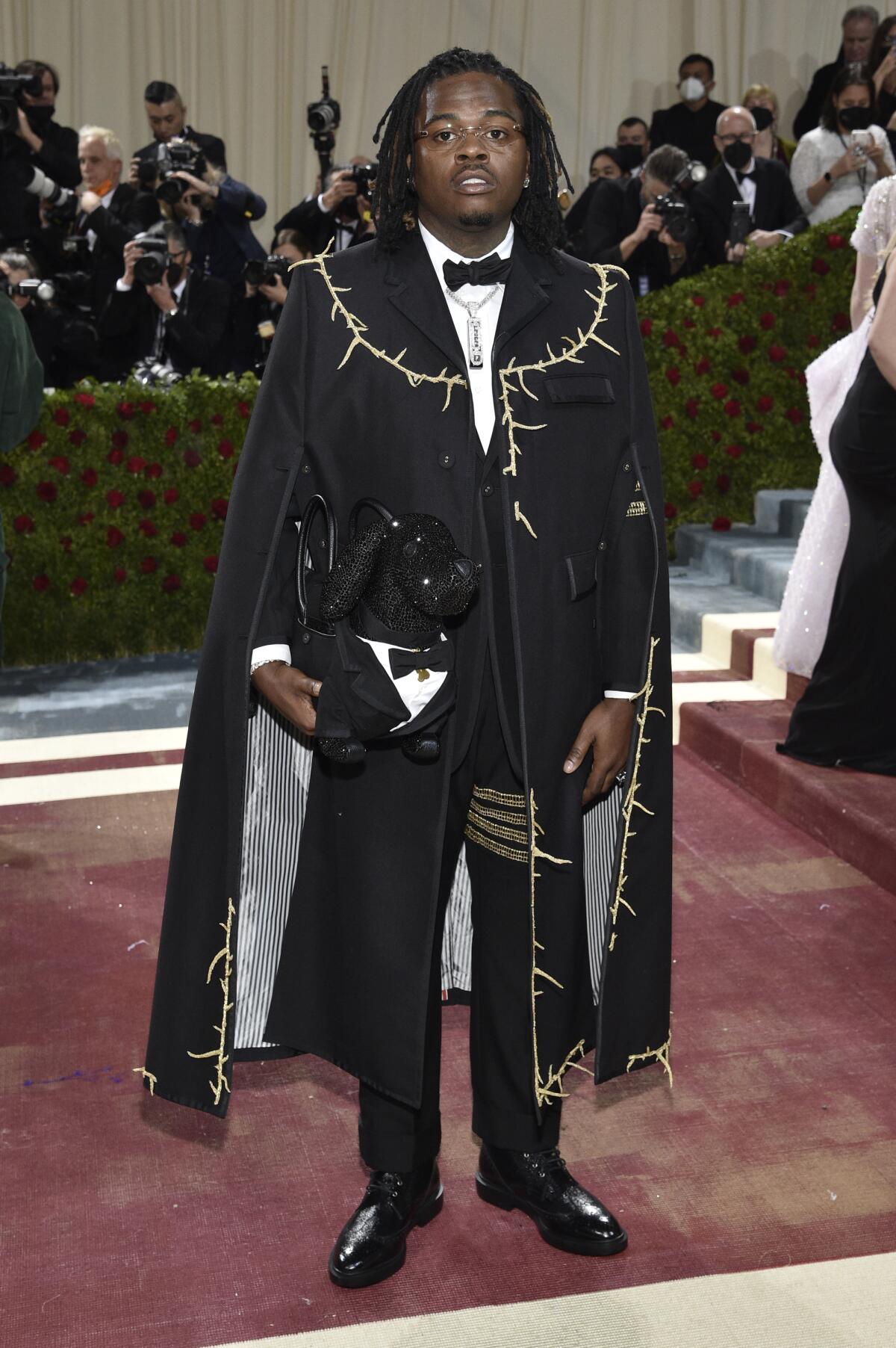 A man wearing a tuxedo with a cape at the 2022 Met Gala