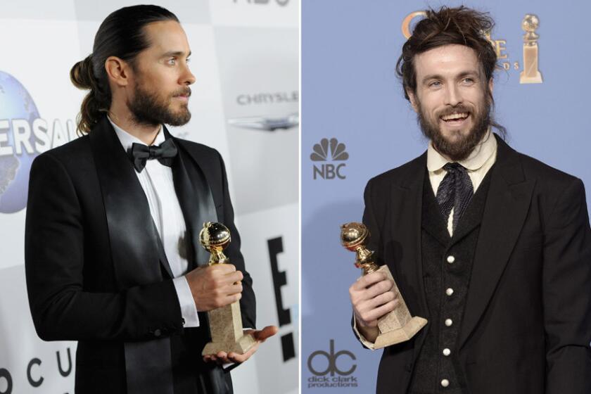 Both musician-actor Jared Leto, left, and musician Alex Ebert won in their categories, and both sported some eclectic man buns.