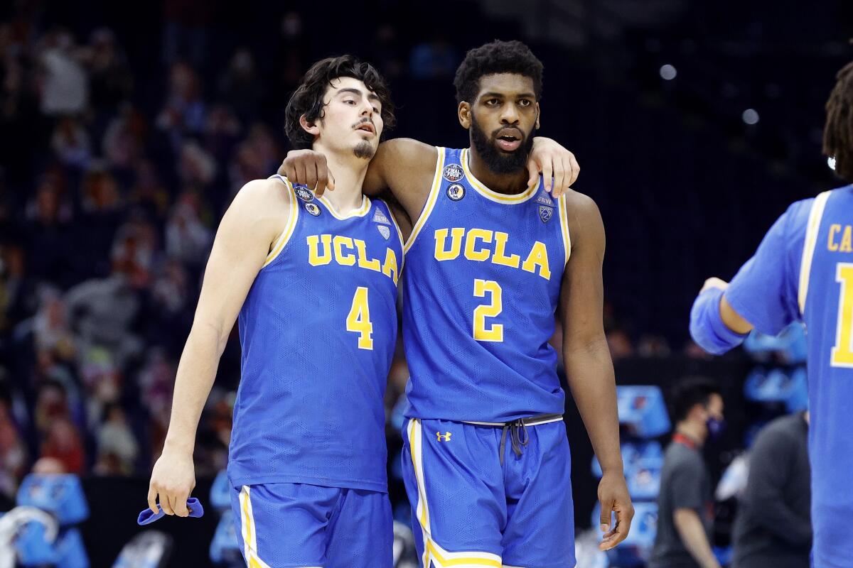 Jaime Jaquez Jr., left, and Cody Riley leave the court together after a 93-90 overtime loss to Gonzaga in the Final Four.