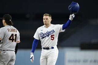 Los Angeles Dodgers' Freddie Freeman, right, acknowledges the fans after hitting his 200th hit.