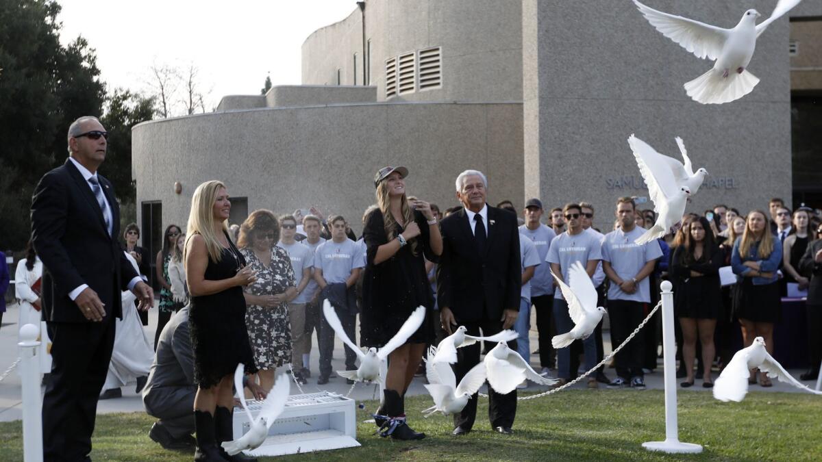 Family members release doves at the memorial for Justin Meek, who was killed in the Borderline shooting.