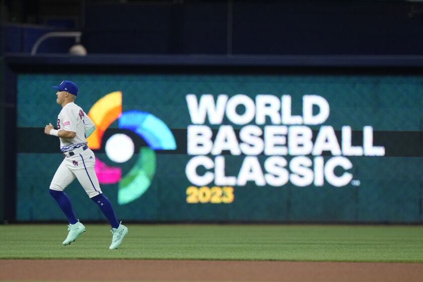 Puerto Rico's Enrique Hernandez warms up before the start of a World Baseball Classic game against Israel, Monday, March 13, 2023, in Miami. (AP Photo/Wilfredo Lee)