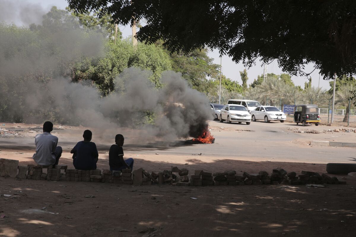 People burn tires in Khartoum, Sudan, Sunday, Nov. 7, 2021. Sudan's protest movement has rejected internationally backed initiatives to return to a power-sharing arrangement with the military after last month's coup, (AP Photo/Marwan Ali)