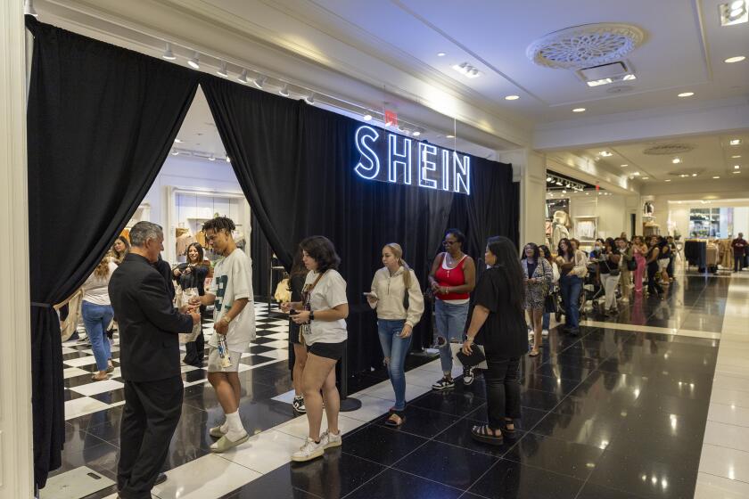 Ontario, CA - October 19: Shoppers Cristopher Lewis, of Fontana and his fiance Raysa Rubio, of Rancho Cucamonga, lead the line of shoppers get the first opportunity to shop on the opening day of fast fashion e-commerce giant Shein, which is hosting a brick-and-mortar pop up inside Forever 21 at the Ontario Mills Mall in Ontario Thursday, Oct. 19, 2023. (Allen J. Schaben / Los Angeles Times)