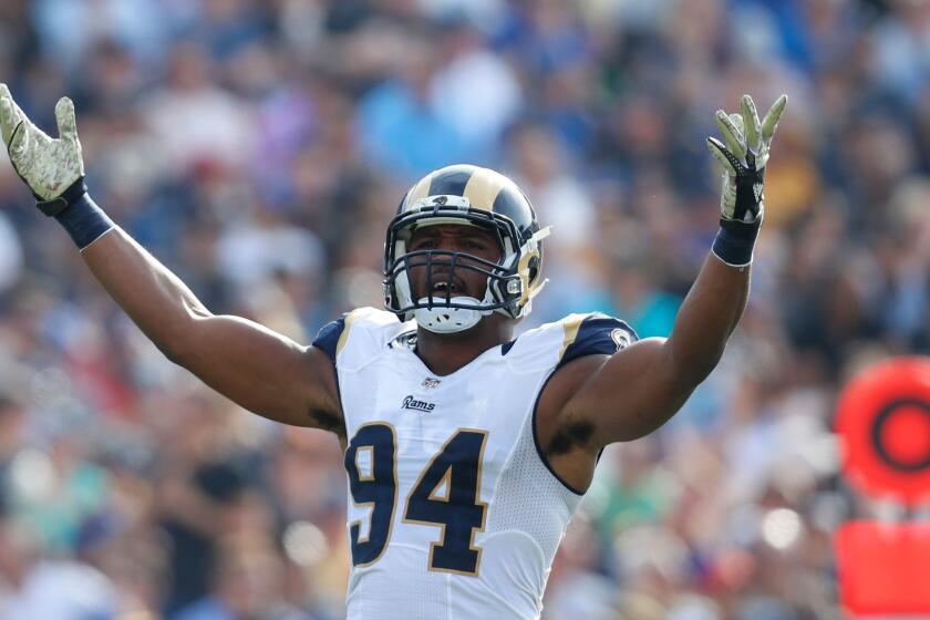 Rams defensive end Robert Quinn gestures to the crowd during a game against the Carolina Panthers at the Coliseum on Nov. 6.