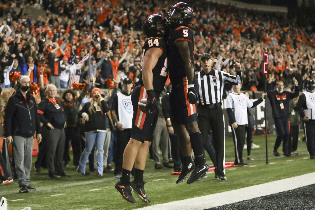 Oregon State tight end Teagan Quitoriano (84) and running back Deshaun Fenwick (5) celebrate Quitoriano's touchdown during the second half of an NCAA college football game Saturday, Nov. 13, 2021, in Corvallis, Ore. Oregon State won 35-14. (AP Photo/Amanda Loman)