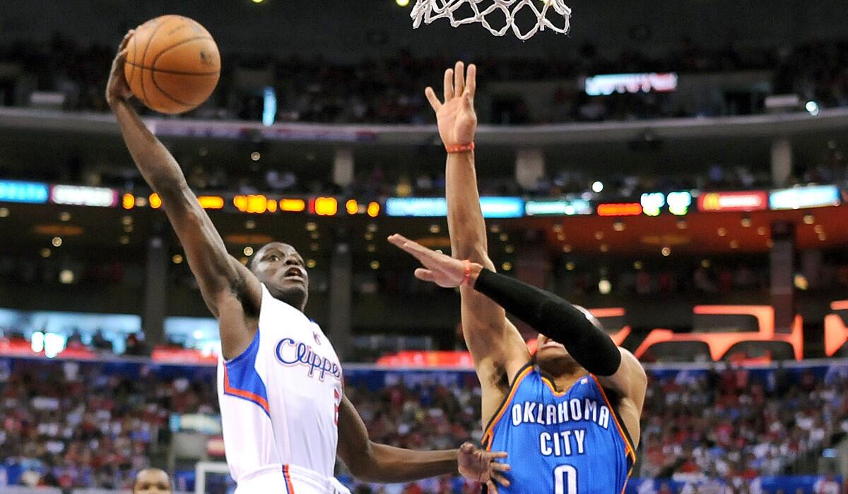 Clippers guard Darren Collison scores on a breakaway in the final minute against Thunder point guard Russell Westbrook to give his team a four-point lead.