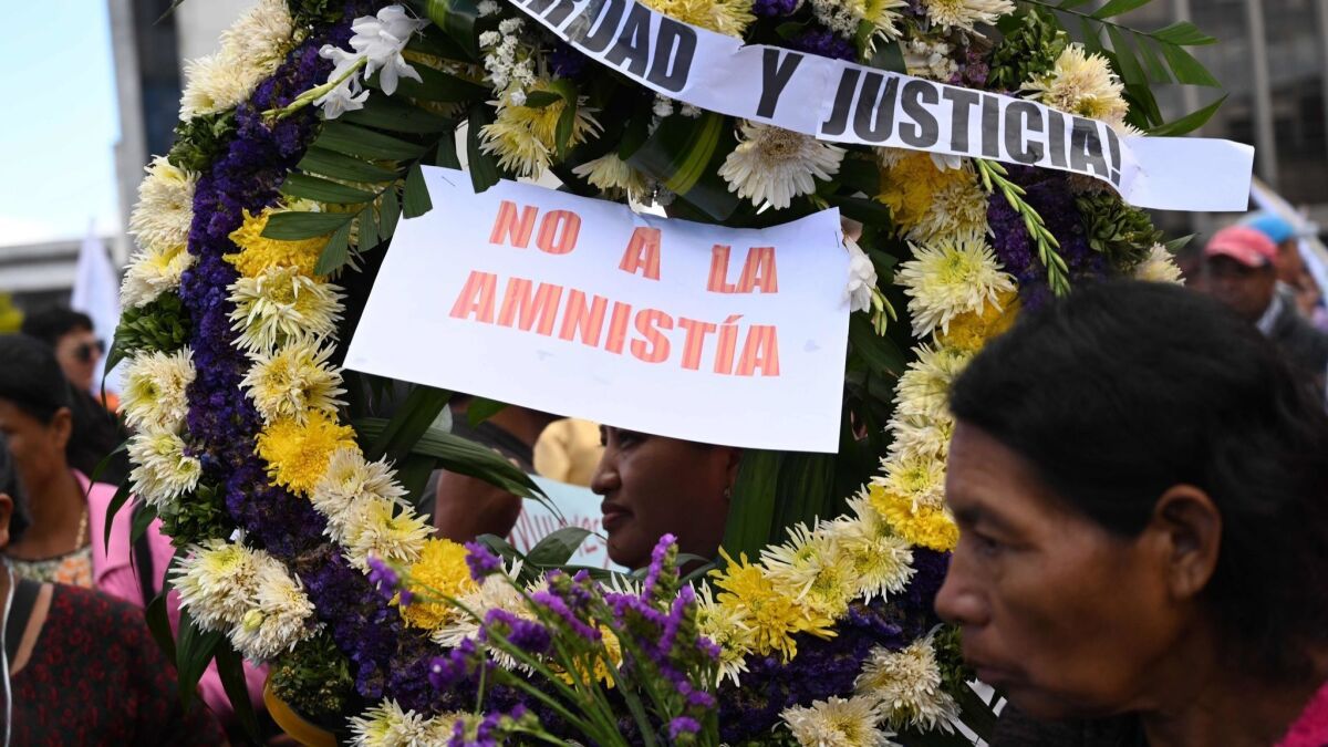 Hundreds of protesters marched from the Supreme Court to the Congress in Guatemala City on Monday.