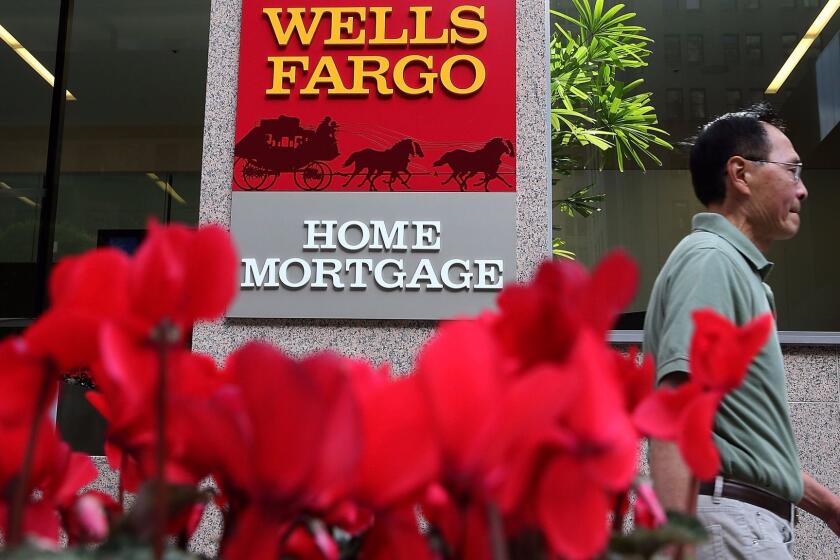 SAN FRANCISCO, CA - OCTOBER 11: A pedestrian walks by a Wells Fargo home mortgage office on October 11, 2013 in San Francisco, California. Wells Fargo reported a 13 percent increase in third-quarter profits with a net income of $5.6 billion, or 99 cents a share compared to $4.9 billion, or 88 cents a share one year ago. (Photo by Justin Sullivan/Getty Images) ** OUTS - ELSENT, FPG, CM - OUTS * NM, PH, VA if sourced by CT, LA or MoD **