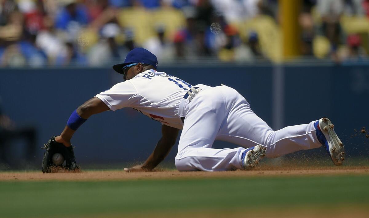 Dodgers shortstop Jimmy Rollins fields a ball hit by Angels' Carlos Perez during the second inning Saturday at Dodger Stadium.