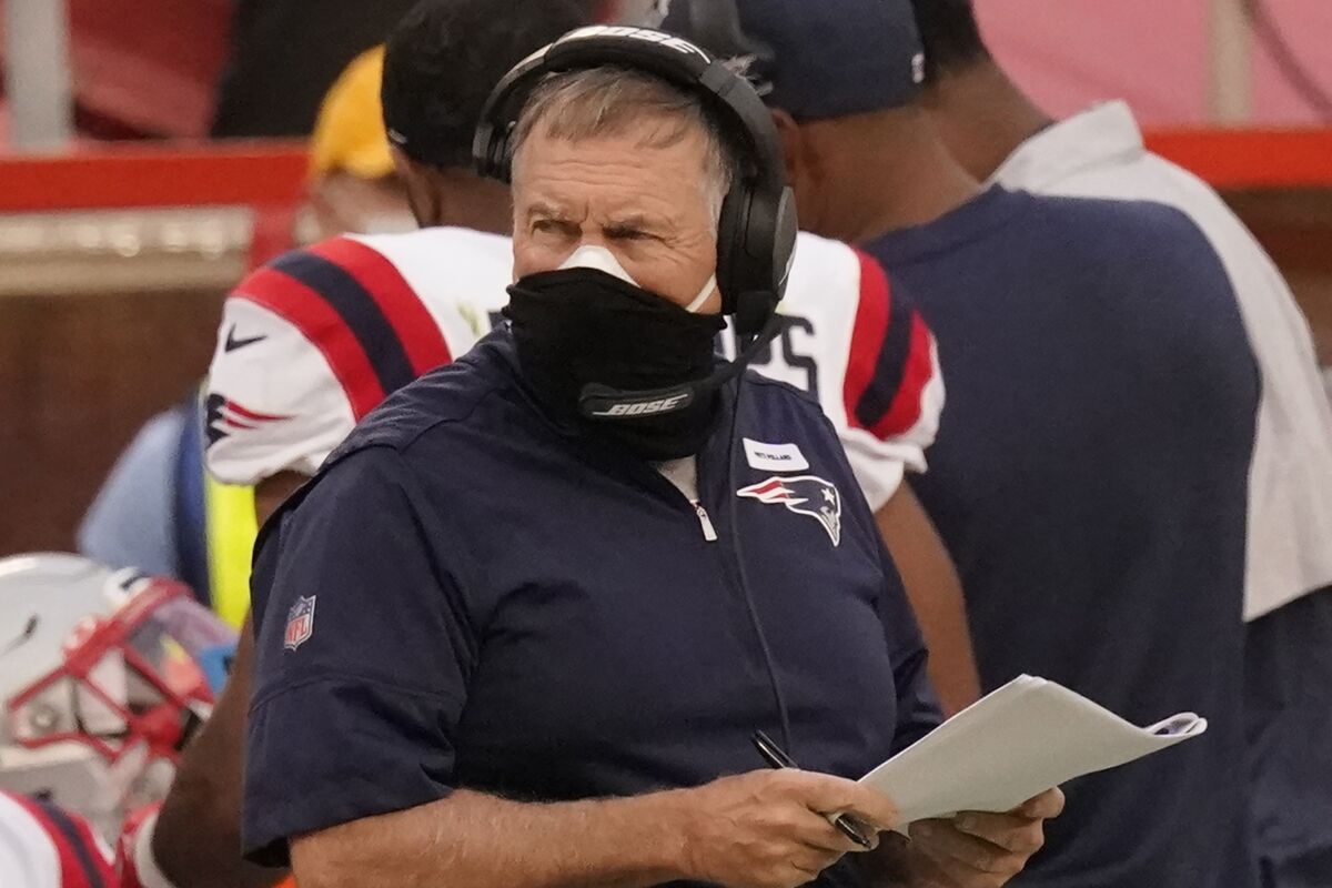 New England Patriots head coach Bill Belichick wears two masks as he watches from the sideline during the first half of an NFL football game against the Kansas City Chiefs , Monday, Oct. 5, 2020, in Kansas City. The New England Patriots have canceled practice amid reports that a third player has tested positive for the coronavirus. Sports Illustrated reported that reigning NFL Defensive Player of the Year Stephon Gilmore tested positive for the virus on Wednesday, Oct. 7, 2020, and was added to the team's reserve/COVID-19 list. (AP Photo/Charlie Riedel)