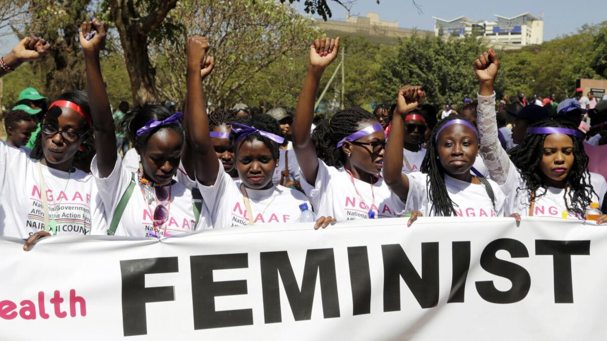 Hundreds of women march in downtown Nairobi, Kenya, highlighting domestic violence, sexual attacks and discrimination in jobs and wages.