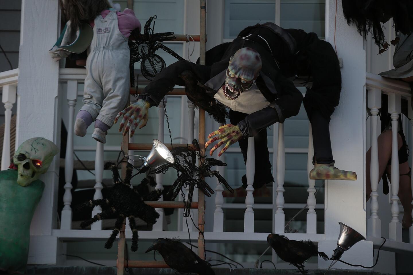 Creepy and whimsical figures adorn the home of Jim and Peggy Rich on Balboa Island. The Riches are one of dozens of families on the island who elaborately decorate their homes for Halloween.