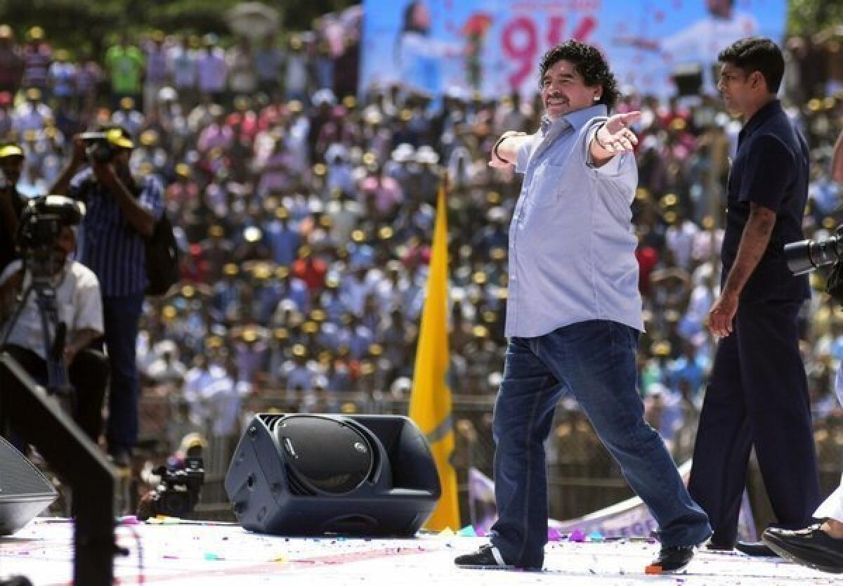 Diego Maradona entertains fans in Kannur, India.