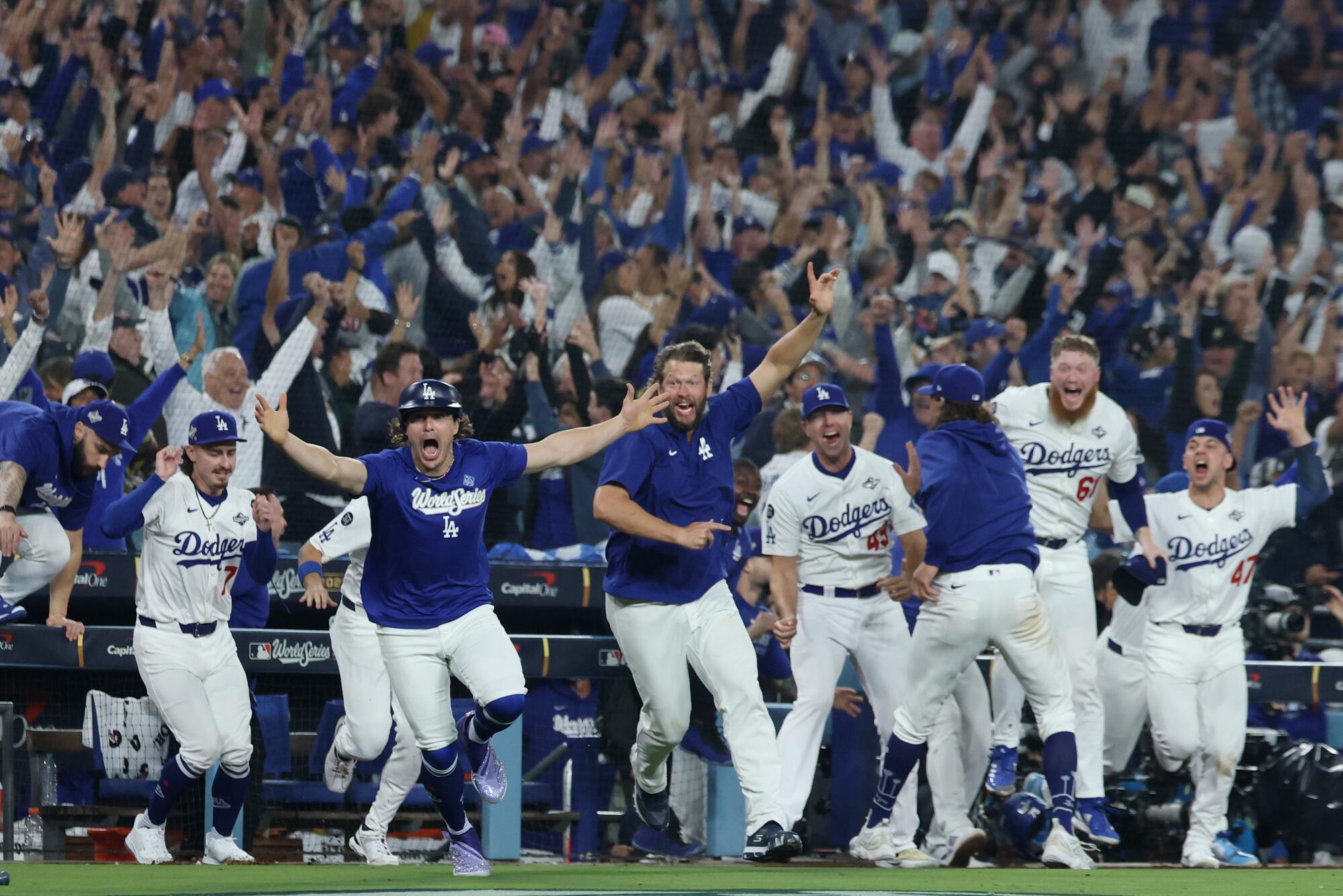 Dodgers players run onto the field after Freddie Freeman's walk-off home run in Game 3.