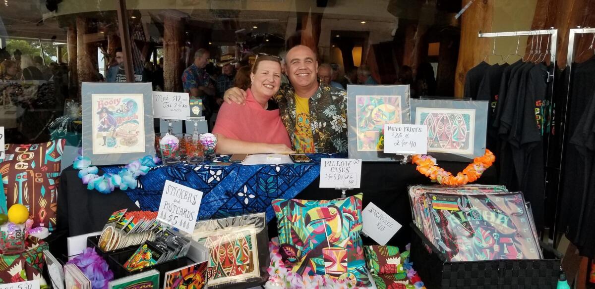 Jeff Granito of Jeff Granito Designs poses with his wife, Katy, at the stand displaying his art on pillow cases, stickers and postcards.